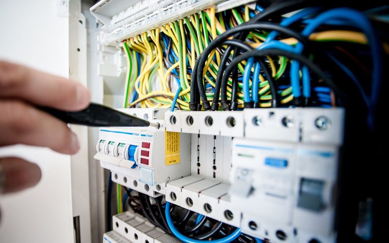 Hands working on a domestic consumer unit